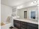 Bathroom featuring double sinks, granite countertops, a tub and tile flooring at 426 Mulberry Se Row, Atlanta, GA 30354