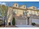 Charming tan townhome with a two-car garage and well-kept landscaping at 426 Mulberry Se Row, Atlanta, GA 30354