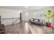 Bright living room featuring wood floors, gray sofa, staircase, and plenty of natural light at 426 Mulberry Se Row, Atlanta, GA 30354