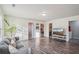 Open concept living room with wood floors, gray sofa, tv, and access to other rooms at 426 Mulberry Se Row, Atlanta, GA 30354