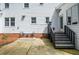 Outdoor patio with access stairs and seating offers a cozy spot for enjoying the serene backyard at 4714 Marc Sw Ct, Lilburn, GA 30047
