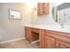 A bathroom featuring an oval mirror, double sinks, and lots of cabinet space at 4714 Marc Sw Ct, Lilburn, GA 30047