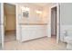 Bathroom with double sink vanity, neutral color palette, tile flooring, and open doorway at 4714 Marc Sw Ct, Lilburn, GA 30047