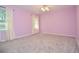 Spacious bedroom with neutral carpet, ceiling fan and natural light from the window at 4714 Marc Sw Ct, Lilburn, GA 30047