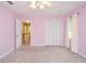Bedroom featuring a closet, neutral carpet, ceiling fan and access to the upper hallway at 4714 Marc Sw Ct, Lilburn, GA 30047