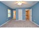 Bedroom with light blue walls, carpet flooring, and white trim at 4714 Marc Sw Ct, Lilburn, GA 30047