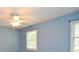 Bedroom featuring light blue walls and two windows with wood blinds at 4714 Marc Sw Ct, Lilburn, GA 30047