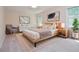 Staged bedroom featuring a bed, framed art and a light color pallette at 4714 Marc Sw Ct, Lilburn, GA 30047