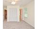 Bright bedroom featuring a ceiling fan, neutral carpeting, and a large closet at 4714 Marc Sw Ct, Lilburn, GA 30047