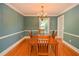 Classic dining room with hardwood floors, chandelier, and traditional table setting offers elegant entertaining at 4714 Marc Sw Ct, Lilburn, GA 30047