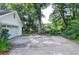 Spacious driveway leading to a detached garage, featuring a basketball hoop and ample parking at 4714 Marc Sw Ct, Lilburn, GA 30047