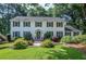 Classic two-story home with manicured lawn, bushes and mature trees, creating curb appeal at 4714 Marc Sw Ct, Lilburn, GA 30047