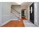 Inviting foyer with hardwood floors, staircase, and doorway leading to another room at 4714 Marc Sw Ct, Lilburn, GA 30047