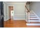 Inviting foyer with hardwood floors, staircase, and doorway leading to another room at 4714 Marc Sw Ct, Lilburn, GA 30047