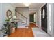 Inviting foyer with hardwood floors, staircase, and doorway leading to another room at 4714 Marc Sw Ct, Lilburn, GA 30047
