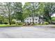 Traditional home with landscaped front yard, mature trees, and an inviting curb appeal at 4714 Marc Sw Ct, Lilburn, GA 30047
