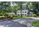 Charming two-story home showcasing a beautifully landscaped front yard with lush greenery and vibrant flowers at 4714 Marc Sw Ct, Lilburn, GA 30047
