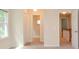 Neutral hallway featuring carpet, doors, and access to the staircase at 4714 Marc Sw Ct, Lilburn, GA 30047