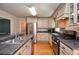 Modern kitchen featuring stainless steel appliances, granite countertops, and ample cabinet space at 4714 Marc Sw Ct, Lilburn, GA 30047