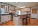 Charming kitchen with stainless steel appliances, breakfast bar, and hardwood floors create a cozy cooking space at 4714 Marc Sw Ct, Lilburn, GA 30047