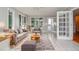 Comfortable living room with tile flooring, large windows, and French doors at 4714 Marc Sw Ct, Lilburn, GA 30047