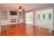 Bright living room featuring a fireplace, built-in shelving, and hardwood floors at 4714 Marc Sw Ct, Lilburn, GA 30047