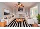 Cozy living room with white sofas, fireplace, built-in shelves, and striped rug at 4714 Marc Sw Ct, Lilburn, GA 30047