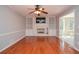 Spacious living room with fireplace, built-in shelves, and hardwood floors at 4714 Marc Sw Ct, Lilburn, GA 30047