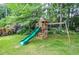 Outdoor playset featuring a slide, swing set, and playhouse, perfect for entertainment at 4714 Marc Sw Ct, Lilburn, GA 30047