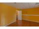 A charming bedroom featuring hardwood floors, a walk-in closet and bright yellow walls at 851 Roget Ct, Lawrenceville, GA 30045