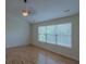 Bright bedroom features hardwood floors, a modern ceiling fan, and a large window at 851 Roget Ct, Lawrenceville, GA 30045