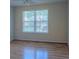 Bedroom with a window providing natural light and hardwood flooring at 851 Roget Ct, Lawrenceville, GA 30045