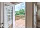 View from inside onto a private deck surrounded by lush greenery, perfect for relaxation at 851 Roget Ct, Lawrenceville, GA 30045