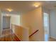 Upstairs hallway with hardwood floors and bright lighting at 851 Roget Ct, Lawrenceville, GA 30045