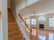 Living room with hardwood floors, a fireplace, and large windows, providing plenty of natural light at 851 Roget Ct, Lawrenceville, GA 30045
