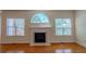 Living room with fireplace, wood floors, and large windows at 851 Roget Ct, Lawrenceville, GA 30045