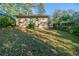 Backyard with grass and trees, shows the back of the home at 1555 Rupert Rd, Decatur, GA 30032
