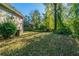 View of the home's expansive backyard, partially shaded with mature trees and lush, green surroundings at 1555 Rupert Rd, Decatur, GA 30032