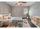 Cozy bedroom with a queen bed, decorative prints, a ceiling fan, and playful toy car accents at 1555 Rupert Rd, Decatur, GA 30032