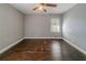 Bedroom with fan, window, and hardwood floors at 1555 Rupert Rd, Decatur, GA 30032