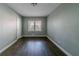 This is a bedroom with dark wood floors, light-grey walls, and one window at 1555 Rupert Rd, Decatur, GA 30032