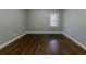 Bedroom with beautiful dark wood floors, light-grey walls, and a window at 1555 Rupert Rd, Decatur, GA 30032