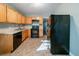 Traditional kitchen with wood cabinets, black appliances, and functional layout at 1555 Rupert Rd, Decatur, GA 30032