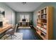 Functional home office with dual desks, ample shelving, and a window view for a productive workspace at 1555 Rupert Rd, Decatur, GA 30032