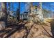 Backyard featuring a house, deck, fencing, and mature trees at 2105 Sandtree Sw Ct, Atlanta, GA 30331