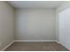 Minimalist bedroom with carpet flooring, light gray walls, and a spacious closet at 2105 Sandtree Sw Ct, Atlanta, GA 30331
