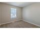Cozy bedroom featuring neutral walls, carpet flooring, and a large window at 2105 Sandtree Sw Ct, Atlanta, GA 30331
