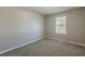 Bedroom with light gray walls, carpeting, window, and white trim at 2105 Sandtree Sw Ct, Atlanta, GA 30331