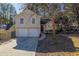 Charming two-story home features a two-car garage and well-maintained lawn at 2105 Sandtree Sw Ct, Atlanta, GA 30331