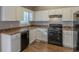 Functional kitchen with white cabinets, laminate counters, and black appliances at 2105 Sandtree Sw Ct, Atlanta, GA 30331